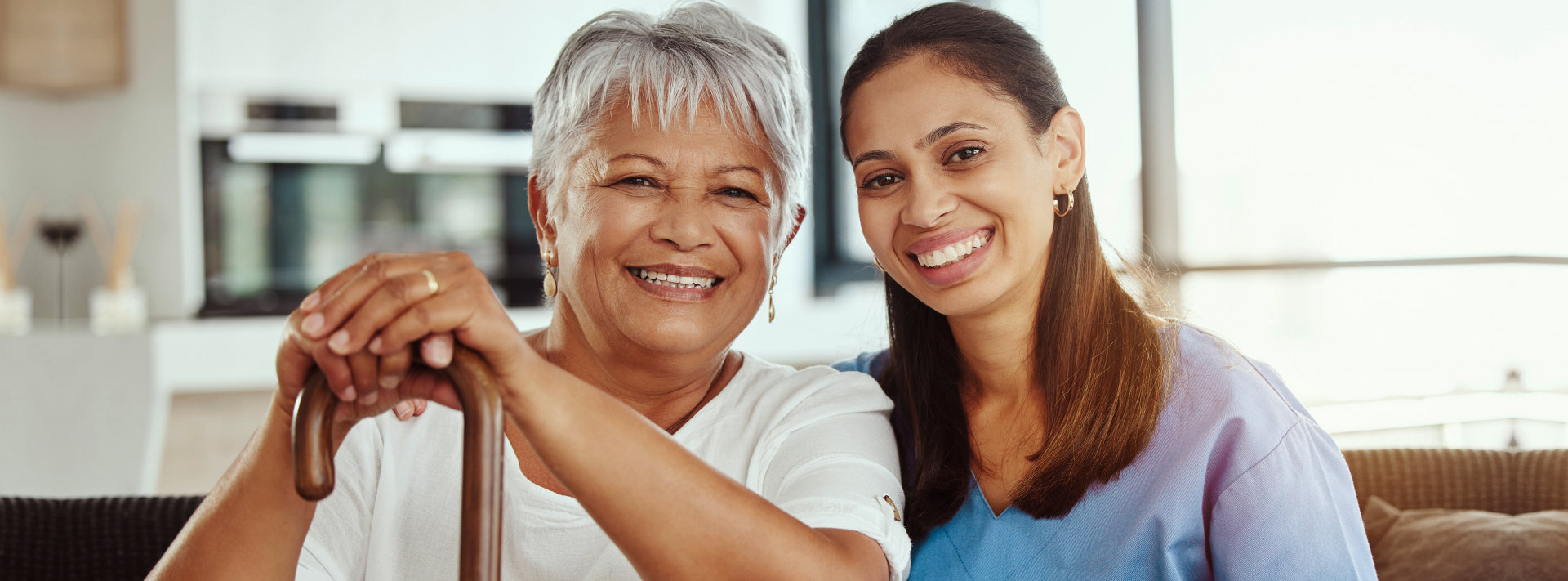 Elderly man and younger woman smiling