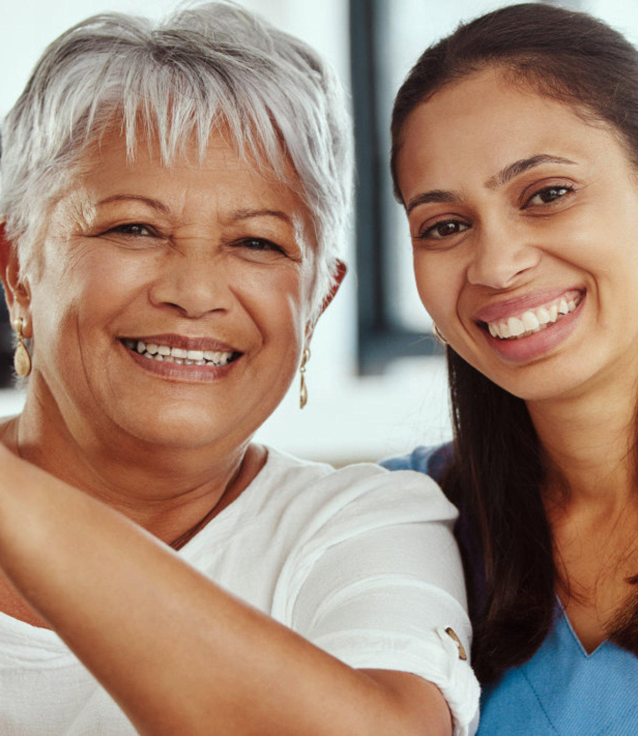 Elderly man and younger woman smiling