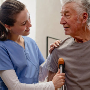 woman assisting elderly man