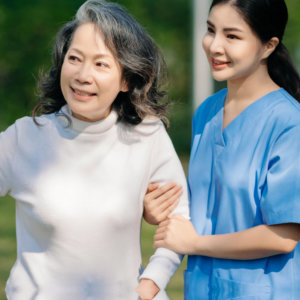 woman holding hand to elderly woman