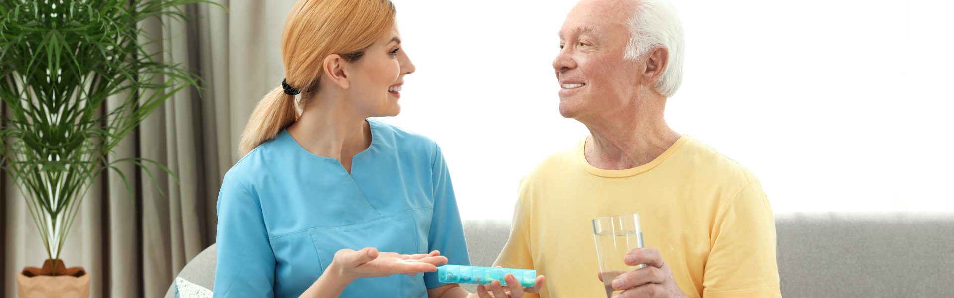 woman with elderly man holding glass