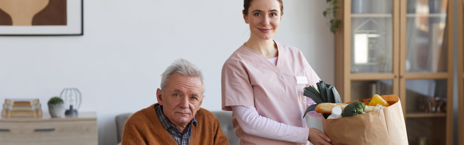 woman holding a bag with elderly man sitting