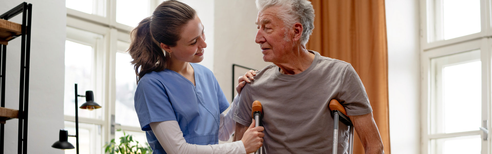 woman assting elderly man