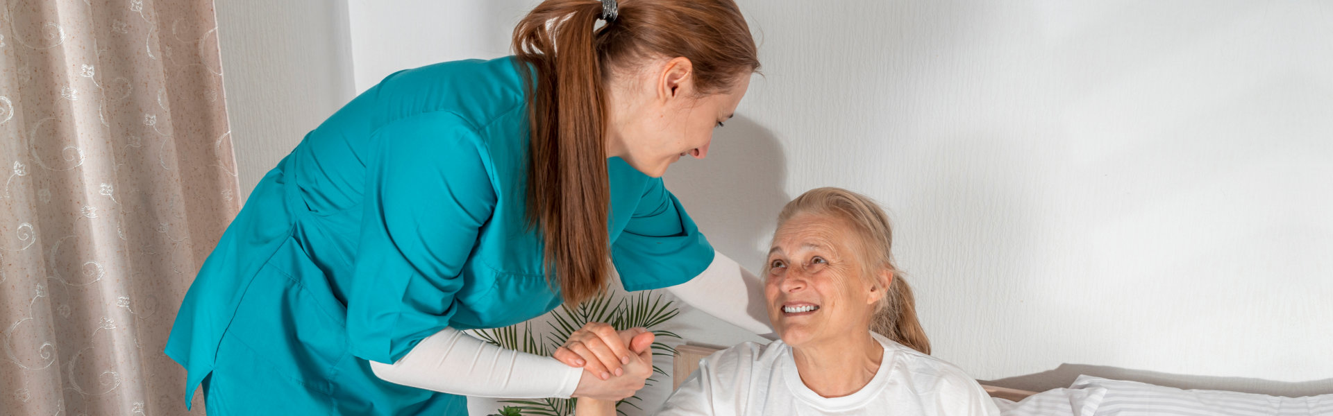 woamn holding hand to elderly woman