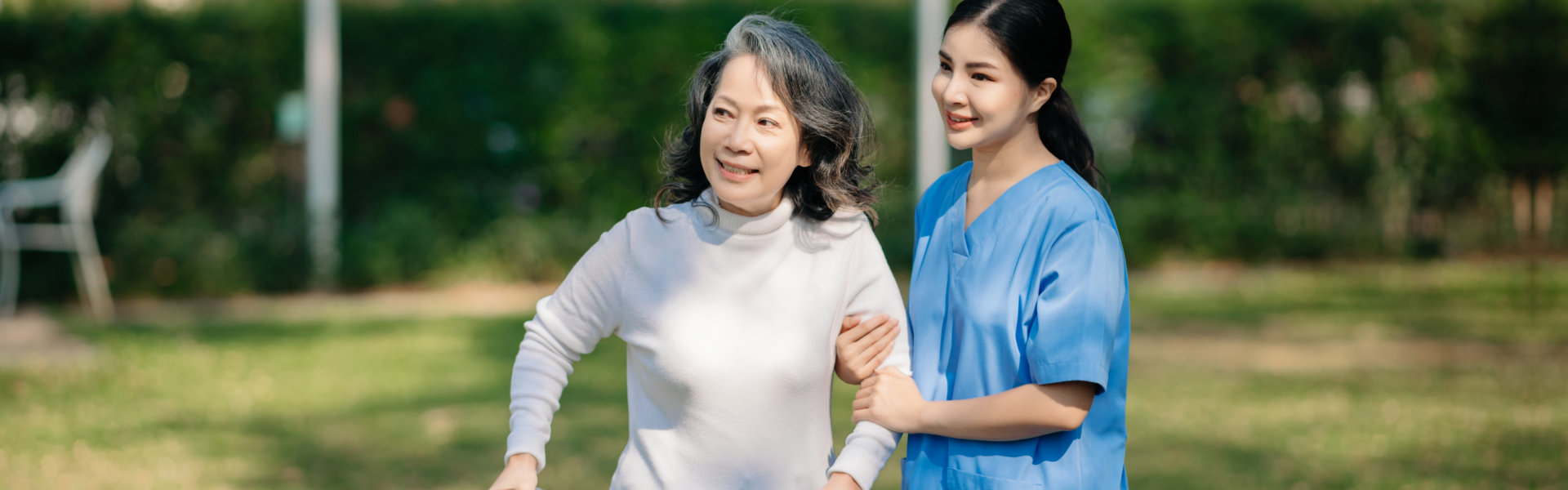 woamn holding hand to elderly woman