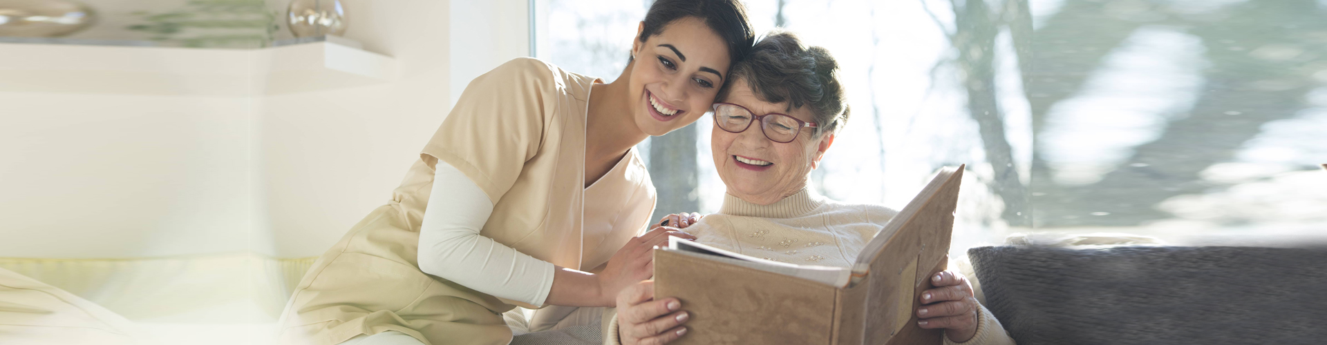 woman and elderly woman reading book